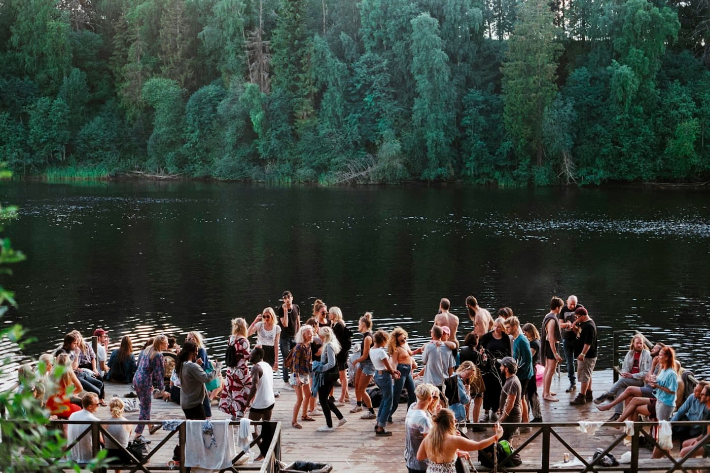 Wedding guests dancing on a lakeside deck